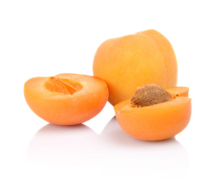 Three sliced apricots isolated on white backgroundの写真素材
