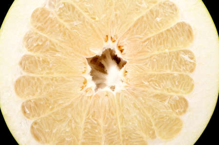 Half of pomelo, chinese grapefruit isolated on black backgroundの写真素材