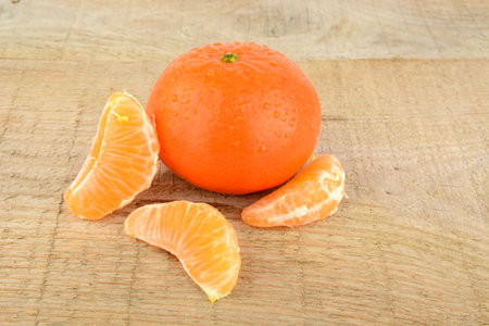 Studio shot mandarines, tangerines on wooden table on white with pieces