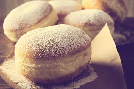 Studio shot of donuts on paper in old-style wallpaper backgroundの写真素材