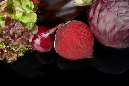 Cropped shot of purple vegetables on black background