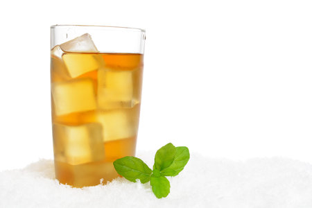 Ice tea with ice cubes,mint on snow on white backgroundの写真素材