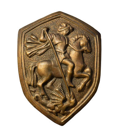 St. George killing the dragon. Bronze bas-relief on the shield. Isolated on whiteの写真素材