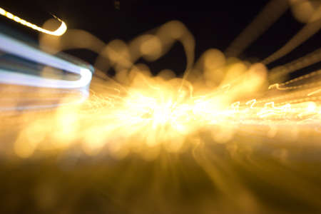 Defocused and motion blurred night scene with traffic lightsの写真素材