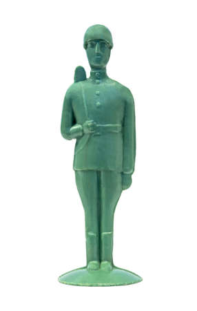 Retro plastic toy soldier with a gun by the shoulder isolated on whiteの写真素材