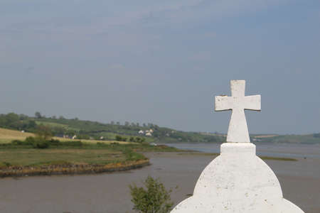 Celtic Cross Wild Atlantic Way background and green landscape of Ireland Location West Cork Timoleague Abbeyの写真素材