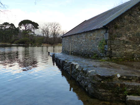 Side of the old stone boathouse by the lakeのeditorial素材