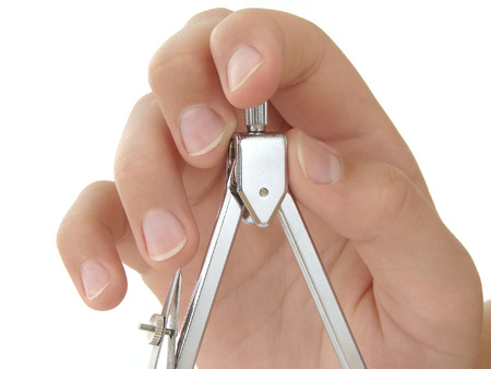 hand with compasses close-up at the white background                               の写真素材