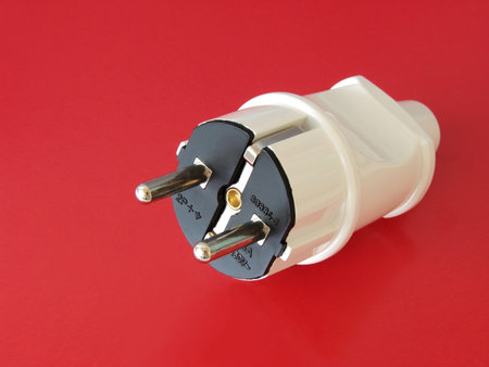 white electrical plug on the red background                               