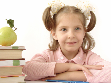 little pretty smiling girl with pile of books                               の写真素材