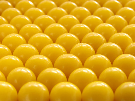 yellow vitamin pills background                               の写真素材