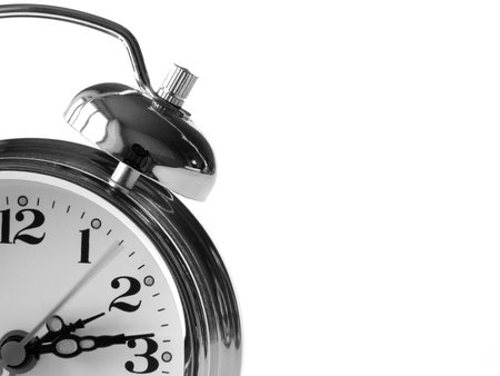 classic alarm clock fragment at the white background                               