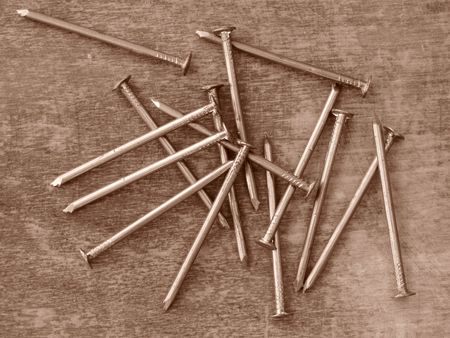 sepia toned some nails on old wooden background                               の写真素材