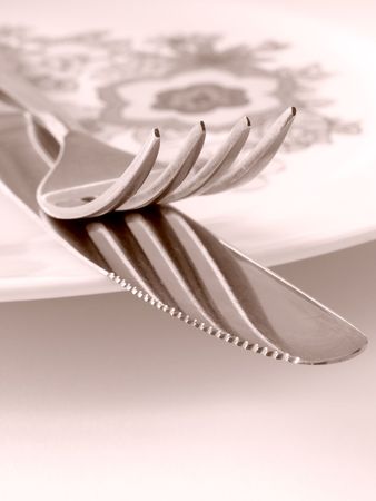 sepia toned abstract fork and knife fragment on the plate                                の写真素材