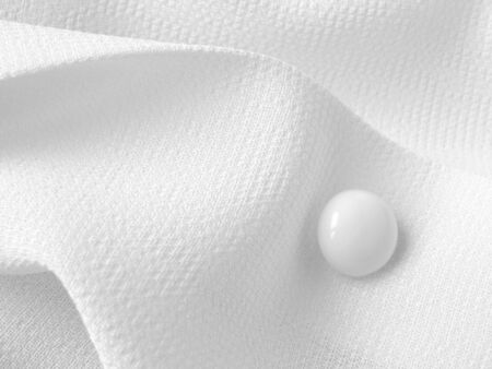 abstract white blouse fragment with button                               の写真素材