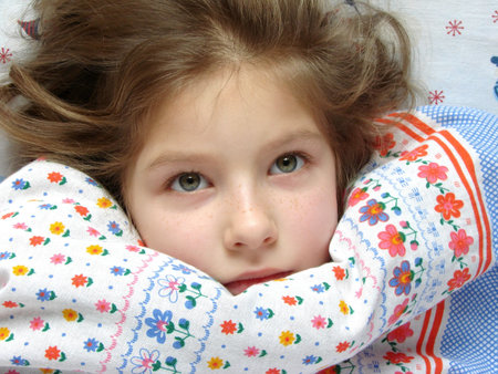 awaken little girl in the bed                               の写真素材