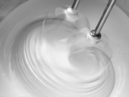 motion blurred dough beating with electric mixer close up                               の写真素材