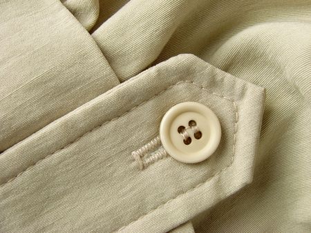 unbleached linen clothes fragment with button                               の写真素材