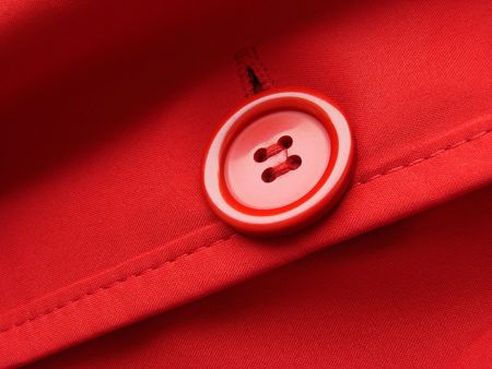 red clothes fragment with button                               の写真素材