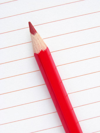 red pencil with blank notepad page                               の写真素材