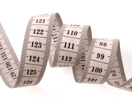 sepia toned curved measuring tape fragment on white                               