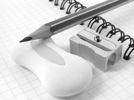 sharpener and pencil with eraser on the workbook page                               の写真素材
