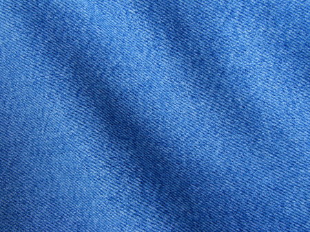folded denim clothes fragment as a background                               