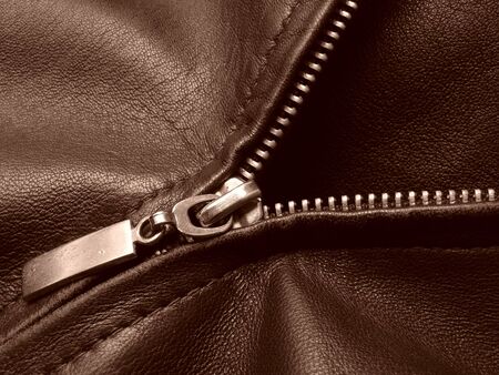 sepia toned leather jacket fragment with metal zipper                               の写真素材