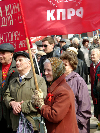 KALUGA, Russia - MAY 1: old woman with red flag on the Russian Labor Day May 1, 2009 in Kaluga,...