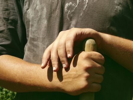hands holding haft of spade                               の写真素材