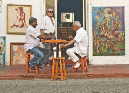 SANTO DOMINGO, DOMINCAN REPUBLIC - MARCH 19: Locals enjoying a domino game at Colonial Zone on March 19, 2011 in Santo Domingo, Dominican Republic. A laid back life style is predominant in this city areaのeditorial素材