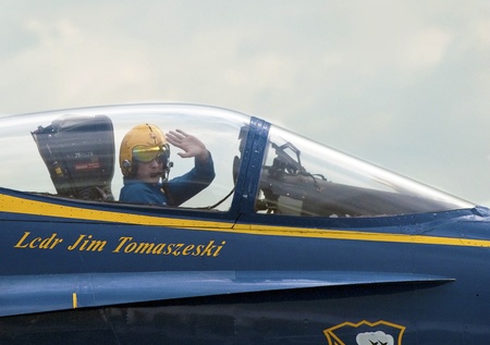 HOMESTEAD, FL - NOVEMBER 6: Blue Angels Jet Pilot Jim Tomaszeski salutes crowd in Homestead Air Force Base after performing on "Wings over Homestead" Air Demonstration Nov 6, 2010 in Homestead, FLのeditorial素材