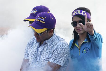 SANTIAGO, DOMINICAN REPUBLIC - MARCH 18: 2012 Elections campaign event on March 18, 2012 at Santiago, Dominican Republic. Candidate for the Country Presidency Danilo Medina supporters in smoke cloud.のeditorial素材