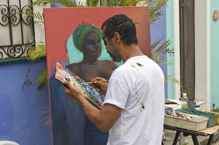 SALVADOR, BRAZIL- DECEMBER 8: Unidentified street artist paints an african woman portrait on December 8, 2012 in Salvador, Brazil. African culture is kept alive in the Bahia state of North Brazil.のeditorial素材