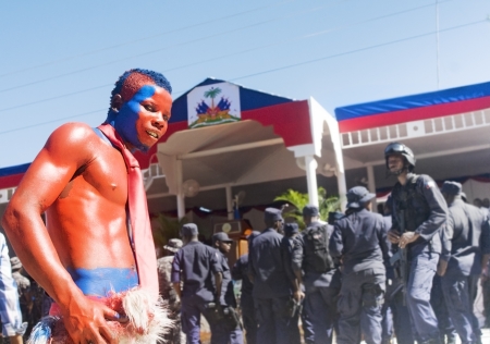 CAP-HAITIEN, HAITI - NOV 18, Supporter of president Martelly with dog and painted with Haiti colors for the president visit on November 18, 2013 in Cap-Haitien, Haitiのeditorial素材