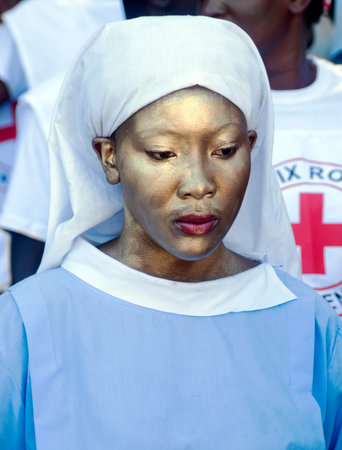 CAP-HAITIEN, HAITI - NOV 18,  Unidentified Haitian painted nurse waiting for the president visit and...