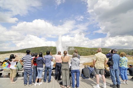YELLOWSTONE NATIONAL PARK, WYOMING - SEPTEMBER 6: Tourists photographing Old Faithful Geyser in Yellowstone National Park on September 6, 2009.のeditorial素材