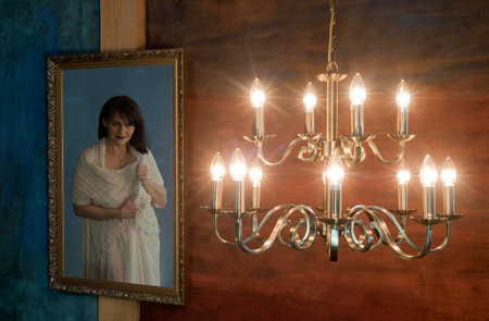 Beautiful girl in a white dress with the interior of the roomの写真素材