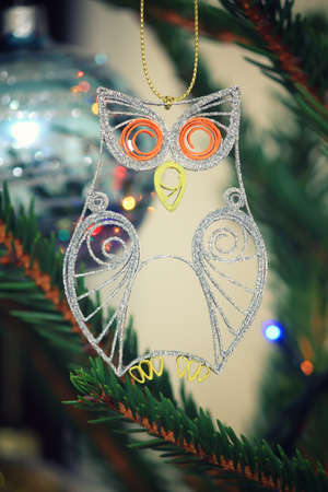 Glitter quilled little owl - handmade Christmas ornament hanging on a spruce branchの写真素材
