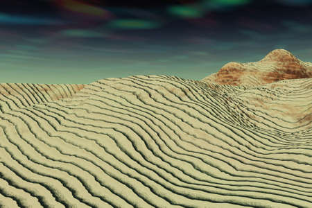 Sandy, wavy soil leading to a mountain.の写真素材