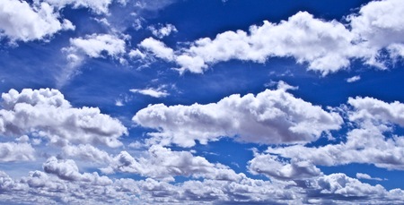 Blue Skies with Puffy White Cloudsの写真素材