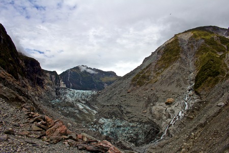 Blue Muddy Glacier Melting on Mountainside in New Zealandの写真素材