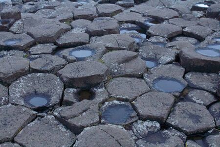 View of the Rocks of Giants Causeway with Puddles on some rocksの写真素材