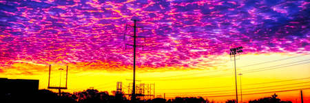 Panorama landscape scene outside of the Pro Football Hall Of Fame of the football goal post that is beside the highway and it is photographed at sunrise.の写真素材