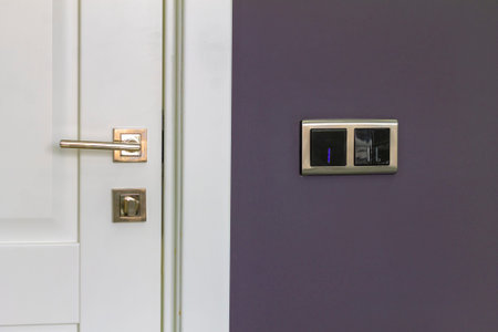 door and doorknob near light switchesの写真素材