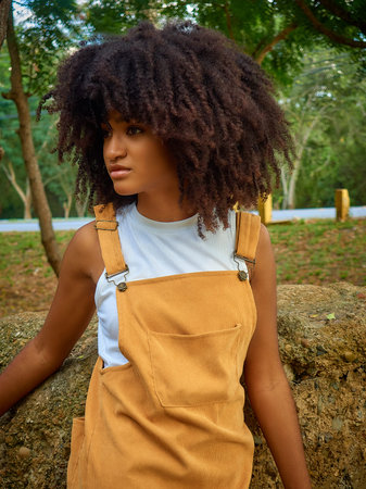 Young girl enjoying nature in central park and smiling with her cute hair