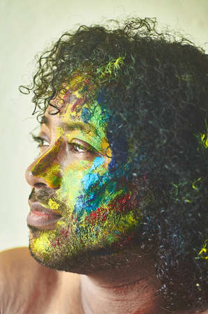 Boy with his face painted in many colors representing artの写真素材