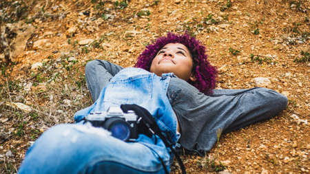 Girl who is dedicated to photography prepares from home to go to take photos of nature.の写真素材