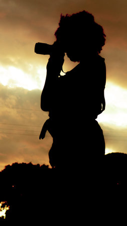 Girl who is dedicated to photography prepares from home to go to take photos of nature.