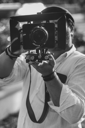 Handsome man taking a photo with vintage camera. Black and white.の写真素材